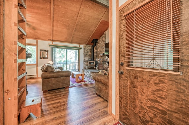 40904 Mill Run Ln Unit 60, Shaver Lake, CA 93664 - living area featuring a wood stove, wood finished floors, wood ceiling, baseboard heating, and vaulted ceiling