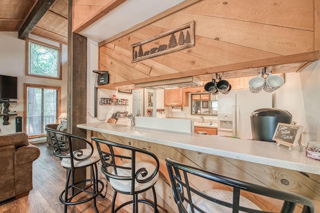 40904 Mill Run Ln Unit 60, Shaver Lake, CA 93664 - kitchen with wood finished floors, light countertops, a peninsula, and white refrigerator with ice dispenser