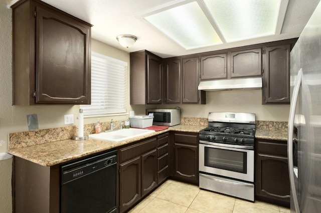 5051 E Lewis Ave, Fresno, CA 93727 - kitchen with under cabinet range hood, appliances with stainless steel finishes, dark brown cabinetry, and light tile patterned flooring