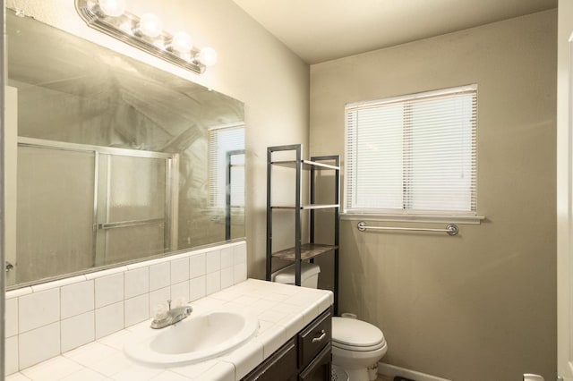 5051 E Lewis Ave, Fresno, CA 93727 - bathroom featuring vanity, a shower with door, and tasteful backsplash