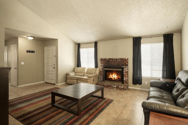 5051 E Lewis Ave, Fresno, CA 93727 - living room with light tile patterned flooring, a textured ceiling, a fireplace, plenty of natural light, and vaulted ceiling