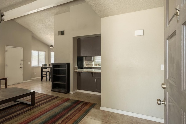 5051 E Lewis Ave, Fresno, CA 93727 - living room featuring a textured ceiling and light tile patterned floors