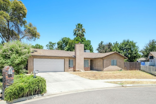 5051 E Lewis Ave, Fresno, CA 93727 - single story home featuring a chimney, a tiled roof, an attached garage, stucco siding, and concrete driveway