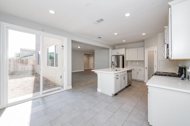 7393 E Michigan Ave, Fresno, CA 93737 - kitchen featuring stainless steel appliances, decorative backsplash, light countertops, recessed lighting, and white cabinets