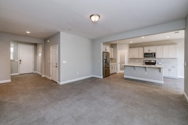 7393 E Michigan Ave, Fresno, CA 93737 - kitchen with appliances with stainless steel finishes, a kitchen breakfast bar, light countertops, white cabinetry, and recessed lighting