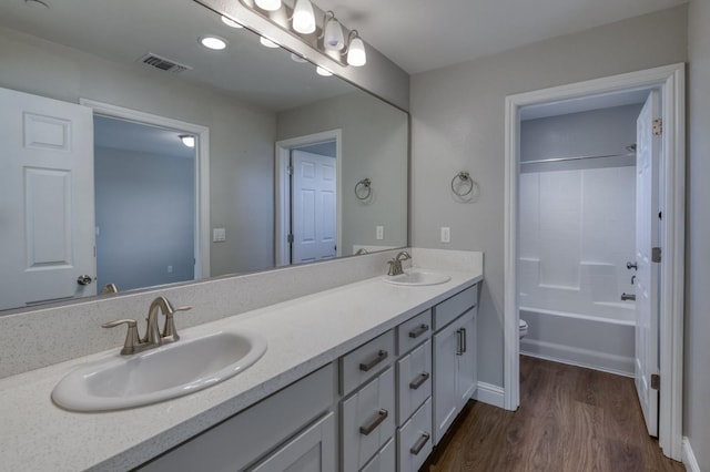 7393 E Michigan Ave, Fresno, CA 93737 - full bathroom featuring double vanity, wood finished floors, and shower / bath combination