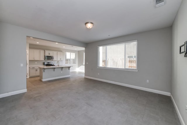 7393 E Michigan Ave, Fresno, CA 93737 - unfurnished living room with a sink and recessed lighting