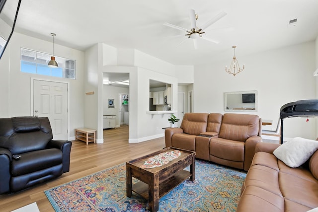 6431 E Inyo St, Fresno, CA 93727 - living room with a ceiling fan, wood finished floors, and a chandelier