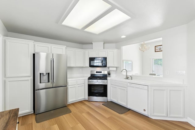 6431 E Inyo St, Fresno, CA 93727 - kitchen featuring stainless steel appliances, light countertops, a chandelier, white cabinets, and light wood-style flooring