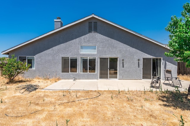 6431 E Inyo St, Fresno, CA 93727 - back of house with stucco siding, a patio, and a chimney