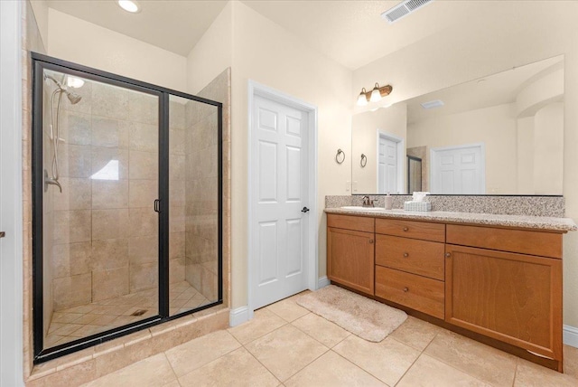2481 S Via Versilia Dr, Fresno, CA 93727 - full bathroom with double vanity, a stall shower, and tile patterned flooring