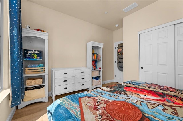 2481 S Via Versilia Dr, Fresno, CA 93727 - bedroom featuring wood finished floors and a closet