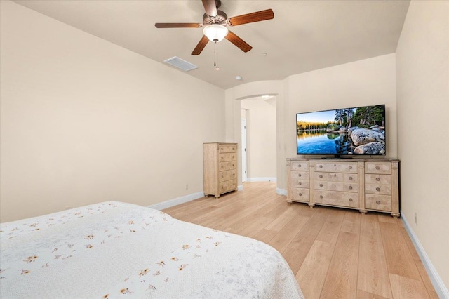 2481 S Via Versilia Dr, Fresno, CA 93727 - bedroom featuring light wood-style floors, arched walkways, and ceiling fan