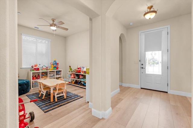 2481 S Via Versilia Dr, Fresno, CA 93727 - entrance foyer featuring arched walkways, wood finished floors, and a ceiling fan