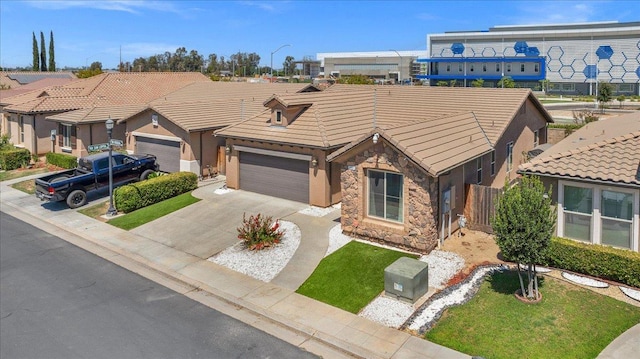 2481 S Via Versilia Dr, Fresno, CA 93727 - view of front of property with stone siding, an attached garage, concrete driveway, a tile roof, and a residential view