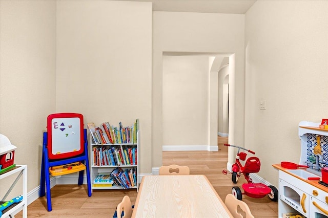 2481 S Via Versilia Dr, Fresno, CA 93727 - playroom featuring wood finished floors and arched walkways