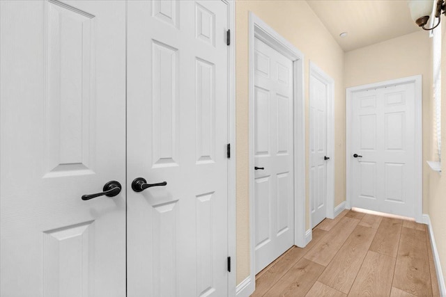 2481 S Via Versilia Dr, Fresno, CA 93727 - corridor featuring light wood-type flooring and baseboards