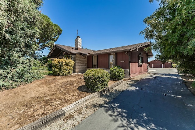 10465 E Herndon Ave, Clovis, CA 93619 - view of front of home featuring a chimney, an outbuilding, and asphalt driveway