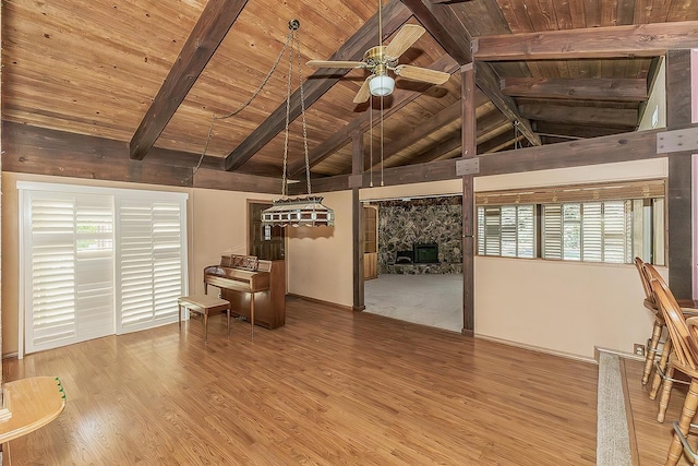 10465 E Herndon Ave, Clovis, CA 93619 - unfurnished living room featuring wooden ceiling, ceiling fan, wood finished floors, plenty of natural light, and a stone fireplace
