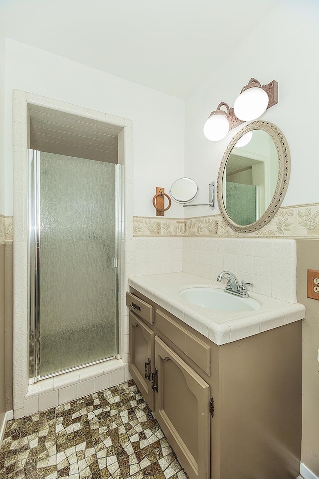 10465 E Herndon Ave, Clovis, CA 93619 - bathroom with vanity, a stall shower, tile walls, and wainscoting