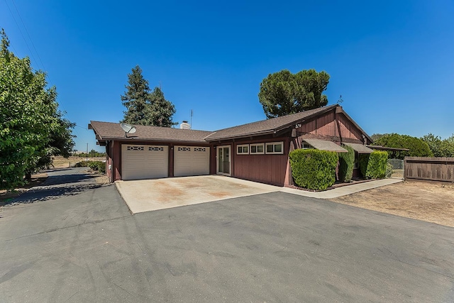 10465 E Herndon Ave, Clovis, CA 93619 - view of front facade featuring an attached garage, driveway, and a chimney