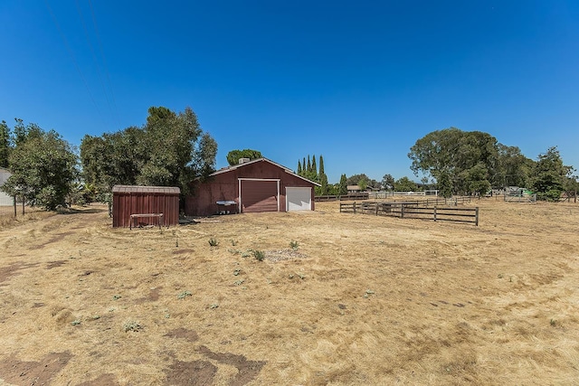 10465 E Herndon Ave, Clovis, CA 93619 - view of yard featuring a detached garage, an outdoor structure, an outbuilding, and a view of countryside