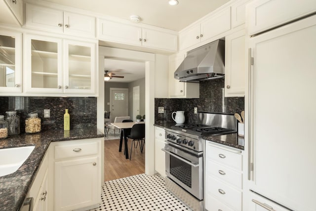 321 E Brown, Fresno, CA 93704 - kitchen with stainless steel range with gas stovetop, ventilation hood, paneled fridge, a ceiling fan, and tasteful backsplash
