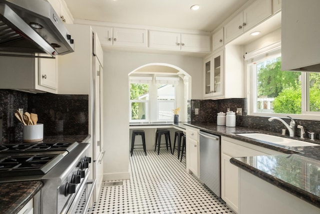 321 E Brown, Fresno, CA 93704 - kitchen with ventilation hood, stainless steel appliances, tasteful backsplash, and white cabinetry