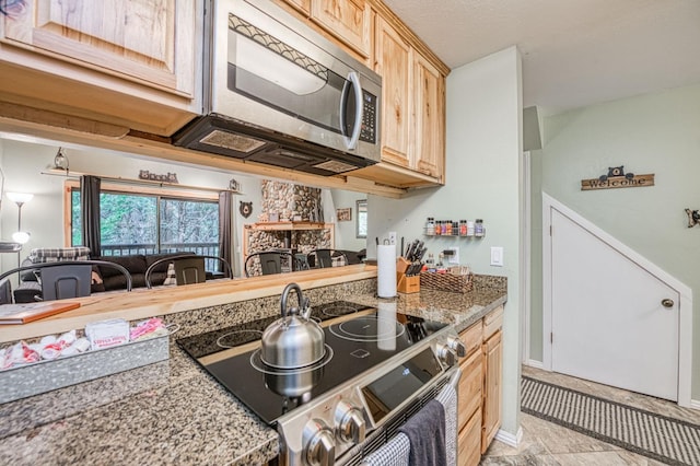 40748 Mill Run Ln Unit 5, Shaver Lake, CA 93664 - kitchen with range with electric stovetop, stainless steel microwave, light brown cabinets, and healthy amount of natural light