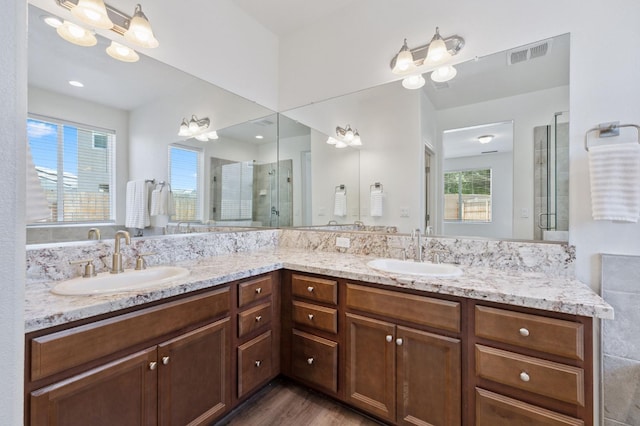 1567 Las Rosas Ave, Clovis, CA 93619 - bathroom with double vanity, a stall shower, and wood finished floors