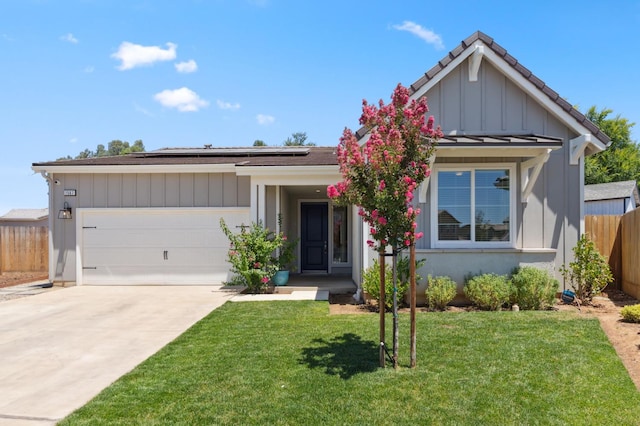 1567 Las Rosas Ave, Clovis, CA 93619 - view of front of property with solar panels, concrete driveway, a garage, and board and batten siding