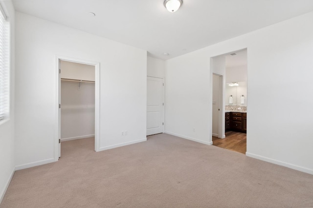 1567 Las Rosas Ave, Clovis, CA 93619 - unfurnished bedroom with light colored carpet, a spacious closet, multiple windows, and ensuite bath