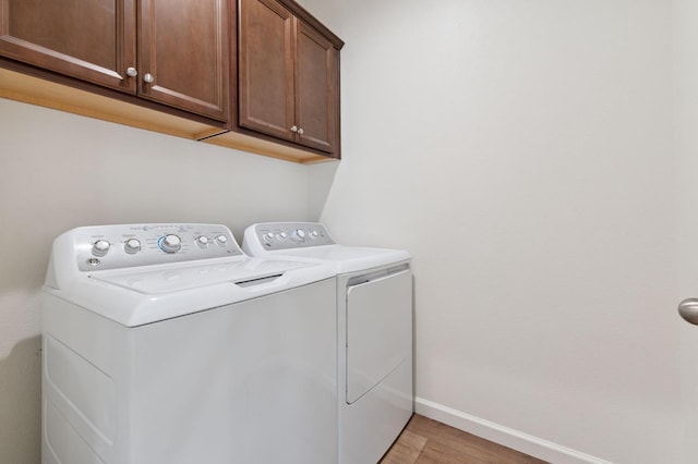 1567 Las Rosas Ave, Clovis, CA 93619 - laundry room with cabinet space, independent washer and dryer, and light wood-type flooring