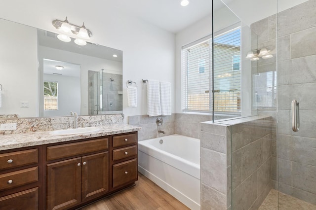 1567 Las Rosas Ave, Clovis, CA 93619 - full bath with a shower stall, vanity, a garden tub, and wood finished floors