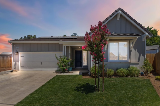 1567 Las Rosas Ave, Clovis, CA 93619 - ranch-style house featuring solar panels, concrete driveway, a garage, and board and batten siding