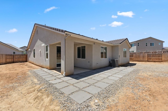 1567 Las Rosas Ave, Clovis, CA 93619 - back of property with stucco siding, a fenced backyard, and a patio
