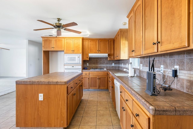 570 S Lassen Ave, Kerman, CA 93630 - kitchen featuring white appliances, under cabinet range hood, ceiling fan, light tile patterned floors, and tile countertops