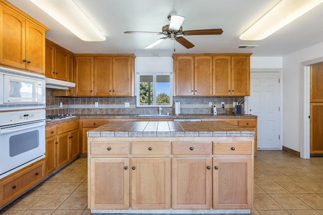 570 S Lassen Ave, Kerman, CA 93630 - kitchen featuring white appliances, a ceiling fan, tasteful backsplash, and tile counters