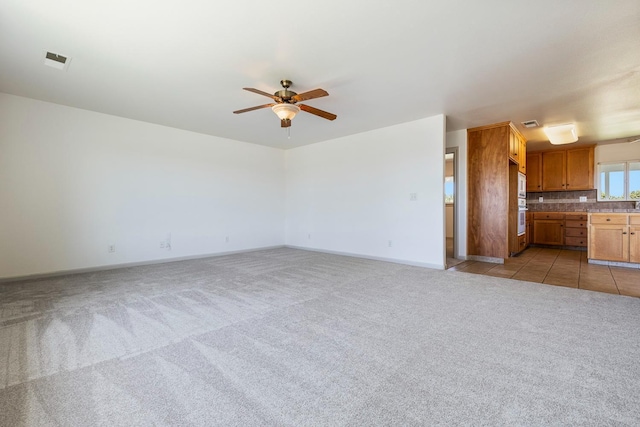 570 S Lassen Ave, Kerman, CA 93630 - unfurnished living room featuring a ceiling fan and light carpet