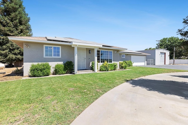 570 S Lassen Ave, Kerman, CA 93630 - ranch-style house with concrete driveway, stucco siding, an attached garage, and roof mounted solar panels
