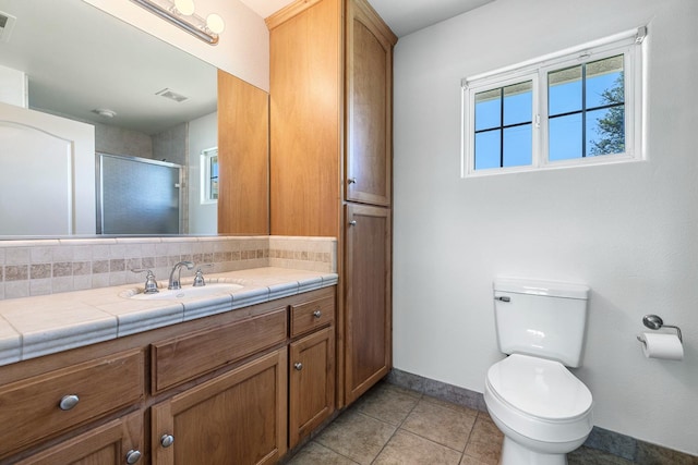 570 S Lassen Ave, Kerman, CA 93630 - full bathroom featuring vanity, plenty of natural light, a shower with shower door, and tile patterned flooring