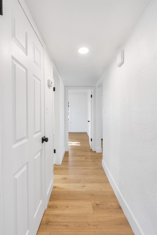 3486 E Lamona Ave, Fresno, CA 93703 - corridor featuring baseboards and light wood-style flooring