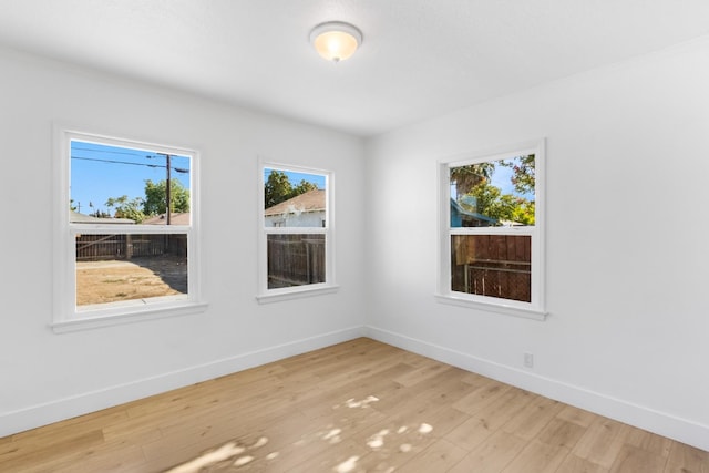 3486 E Lamona Ave, Fresno, CA 93703 - spare room featuring baseboards and wood finished floors