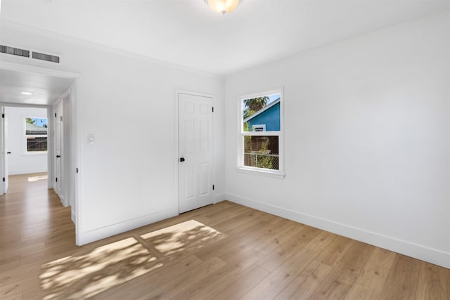 3486 E Lamona Ave, Fresno, CA 93703 - empty room with plenty of natural light, light wood-style flooring, and crown molding