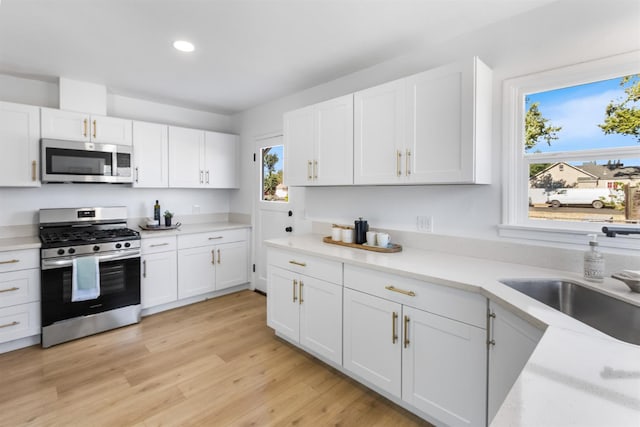 3486 E Lamona Ave, Fresno, CA 93703 - kitchen featuring appliances with stainless steel finishes, white cabinets, and recessed lighting
