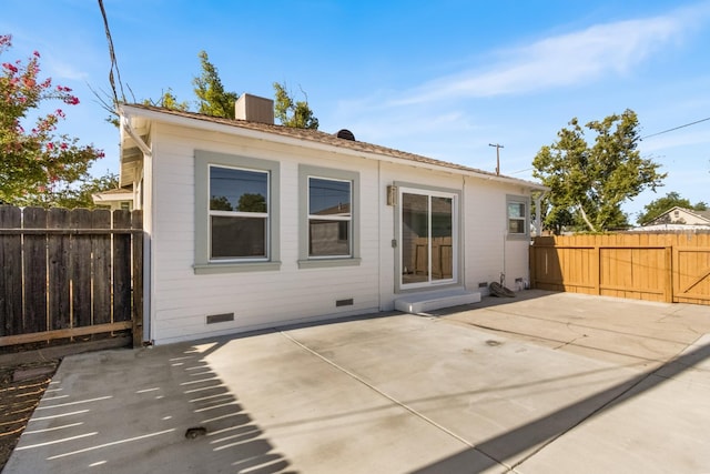 3486 E Lamona Ave, Fresno, CA 93703 - back of house with crawl space, a patio, a fenced backyard, and a chimney