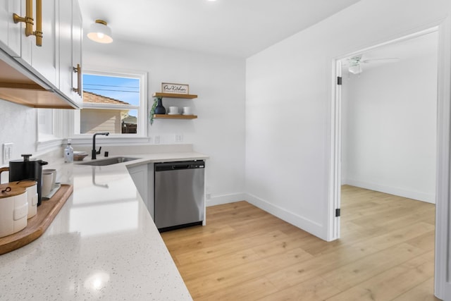 3486 E Lamona Ave, Fresno, CA 93703 - kitchen with dishwasher, white cabinetry, light wood-type flooring, light stone counters, and a ceiling fan