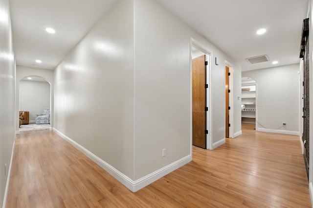 135 N Park Dr, Madera, CA 93637 - corridor with arched walkways, light wood-style floors, and recessed lighting