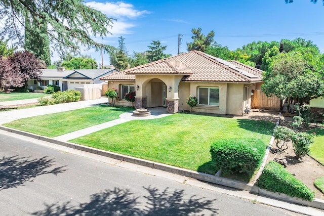 135 N Park Dr, Madera, CA 93637 - mediterranean / spanish-style house with stucco siding, a tile roof, driveway, and an attached garage