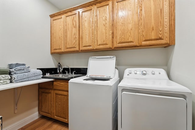 135 N Park Dr, Madera, CA 93637 - washroom with cabinet space, washing machine and clothes dryer, and light wood-style floors
